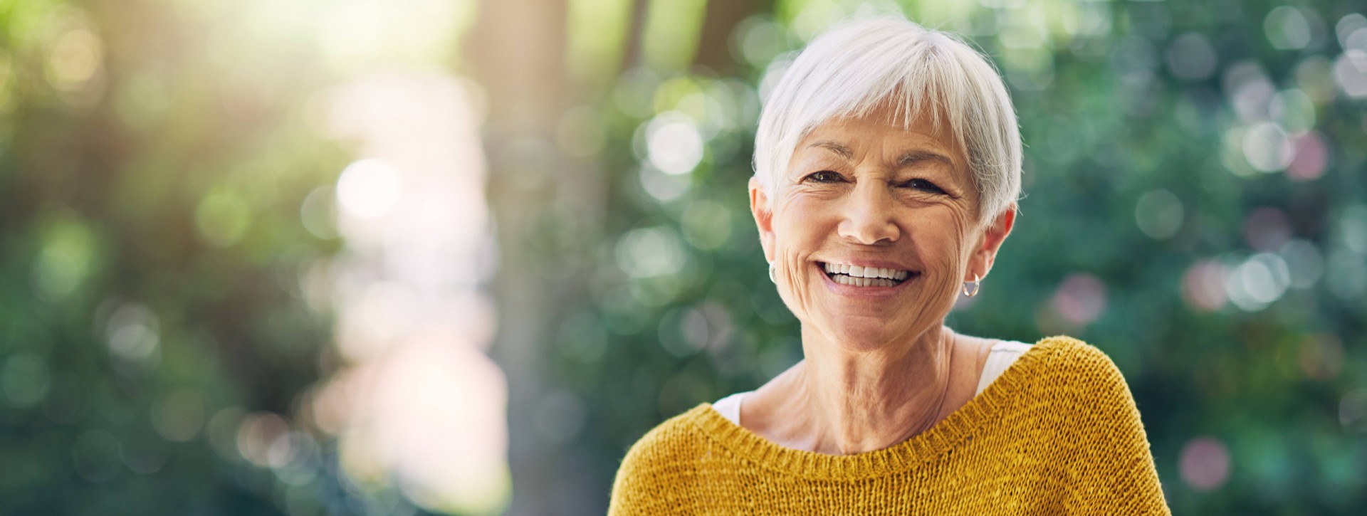 Older Woman Sitting Outside Smiling