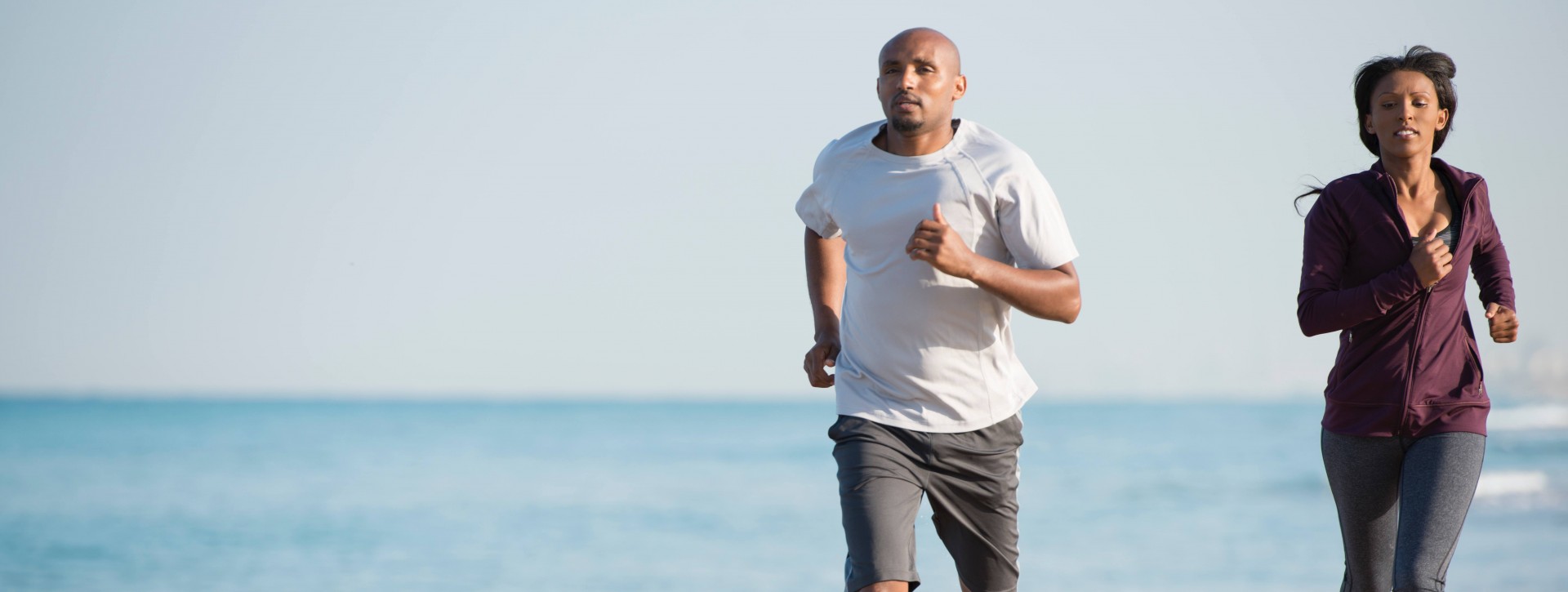 Couple Running On Beach